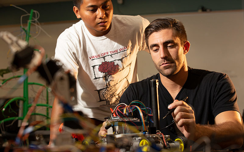 Engineering students work on their seeing-eye robot.