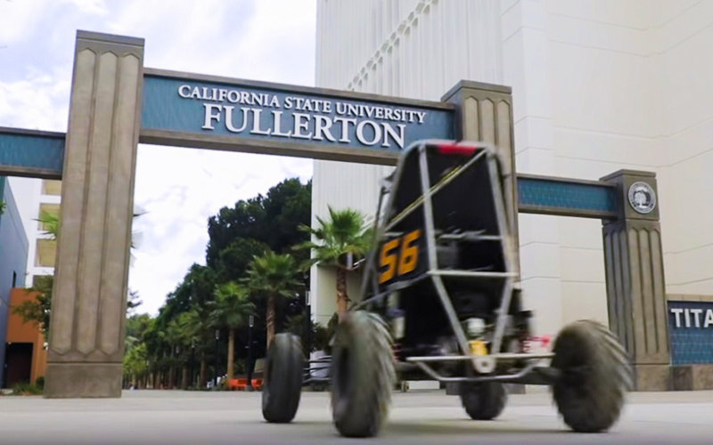 President Virjee Drives a Baja Racer on campus during the student convocation.