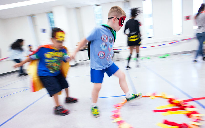 Costumed children play on a course.