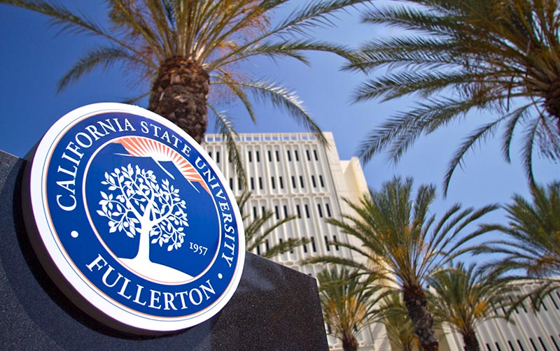 CSUF seal monument with Langsdorf Hall in the background