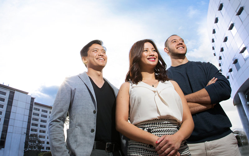 three young adults standing