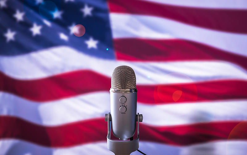 Vice President Debate stage with flag and microphone.