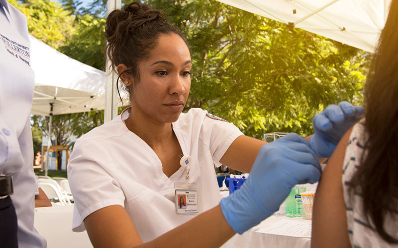 Nurse giving vacination