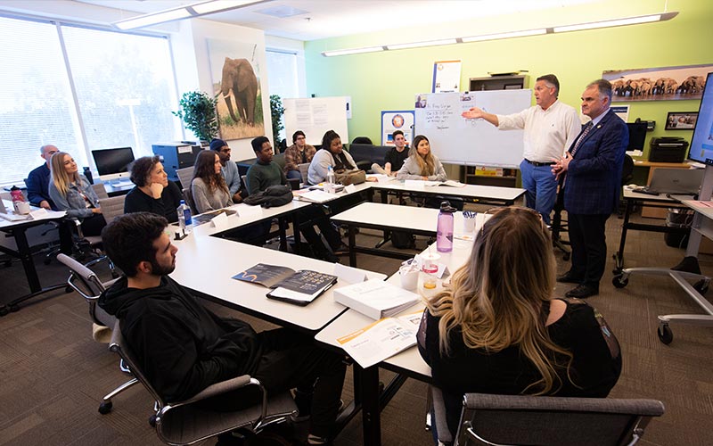 President Fram Virjee meets students at the university’s Irvine Center