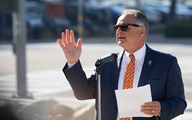 Fram Virjee speaking at podium.