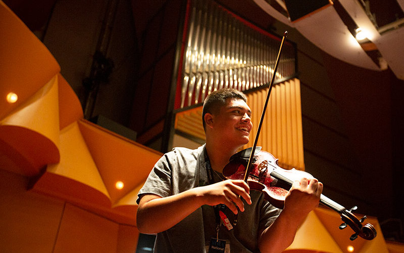 Student playing violin.