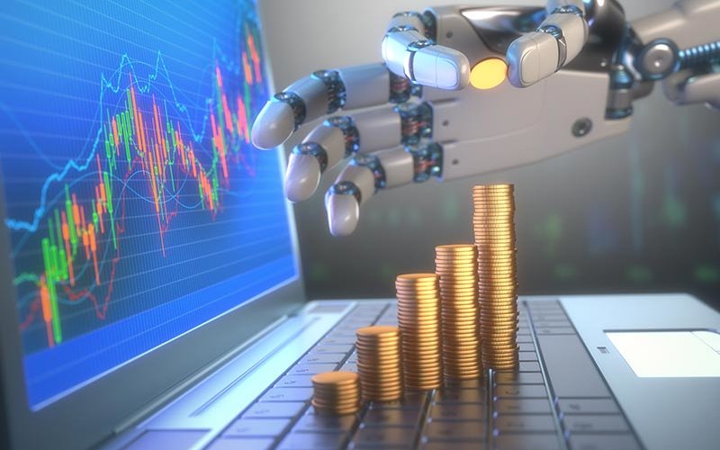 A robot hand counting money on laptop with graph on the rise