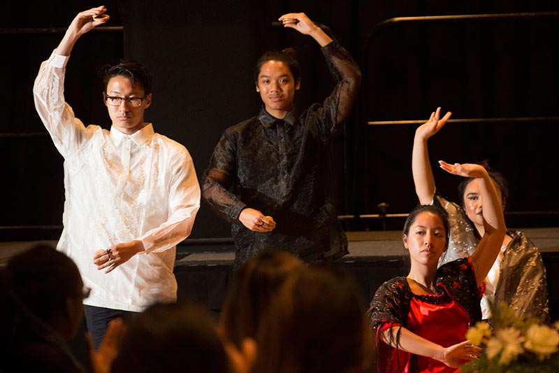 Asian students performing traditional dance.