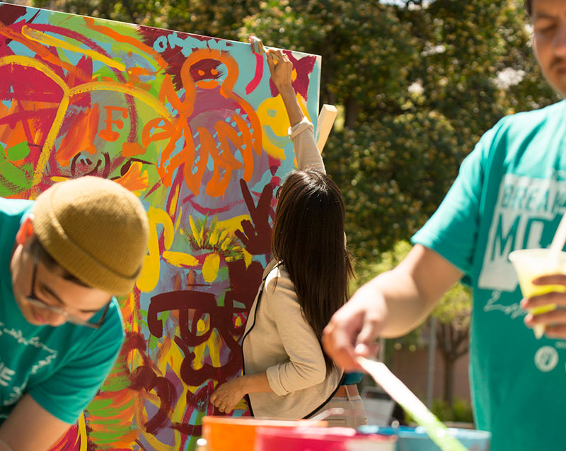 Student painting during Arts Week