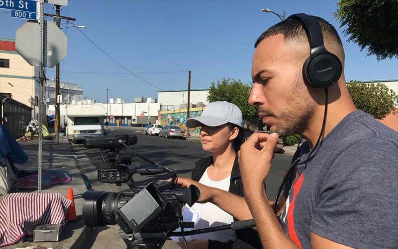 CSUF student looking into video camera view finder