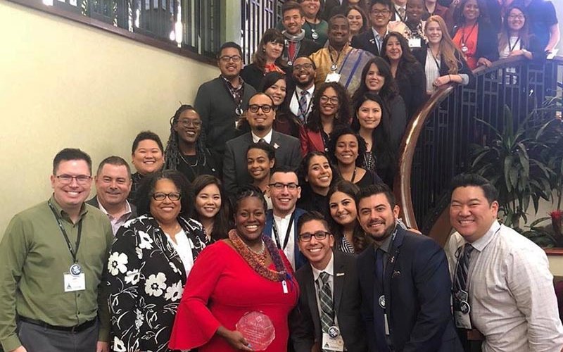 Dr. Berenecea holding Eanes NASPA Award among group of colleagues