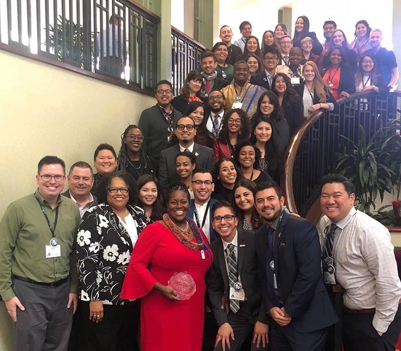 Dr. Berenecea holding Eanes NASPA Award among group of colleagues