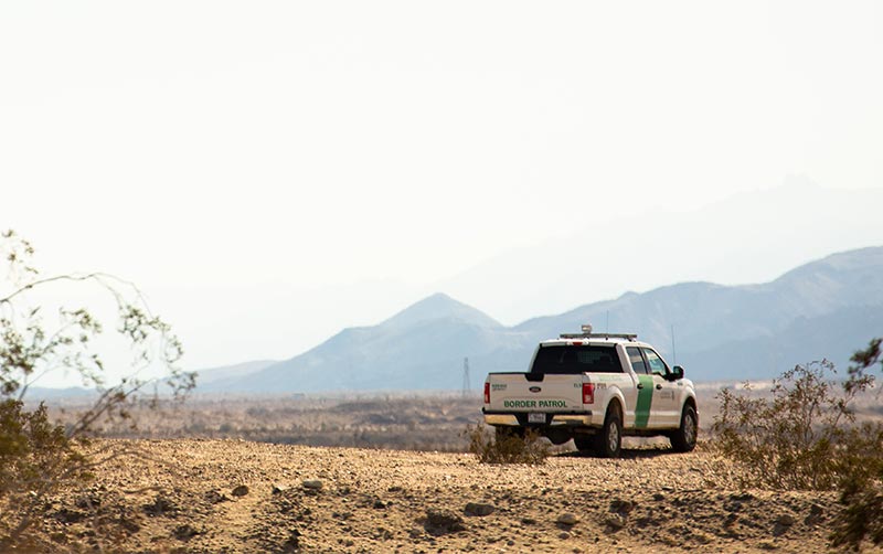 Border patrol vehicle with desert in background