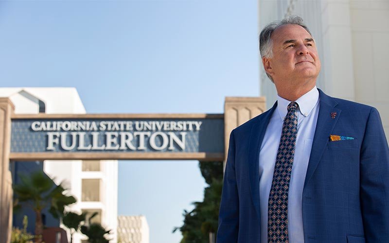 President Fram Virjee stands in front of the CSUF gateway