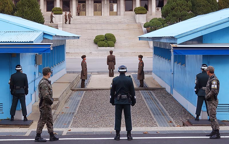 DMZ with South and North Korean soldiers facing each other.