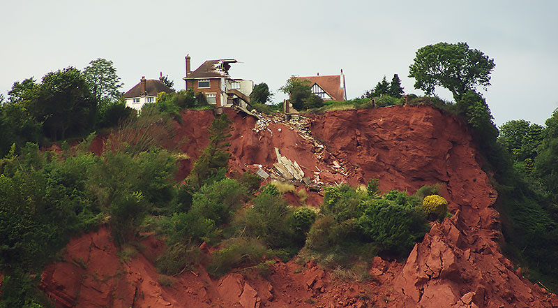 House collapsing off a landslide.