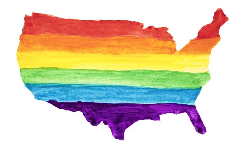 Watercolor painted rainbow United States of America map outline.