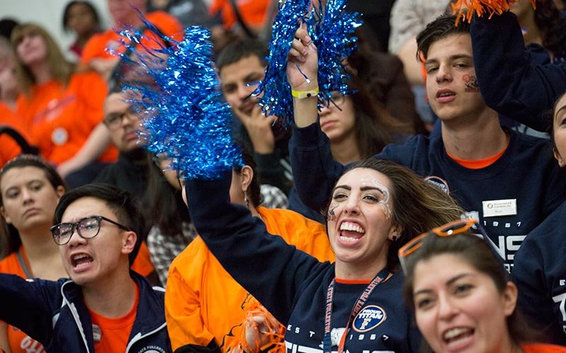 Students cheering at a basketball game.