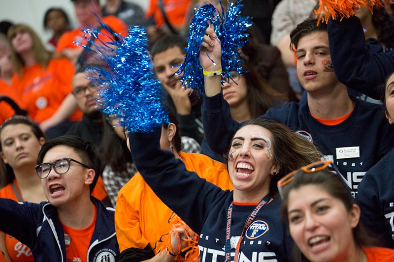 Students cheering at a basketball game.