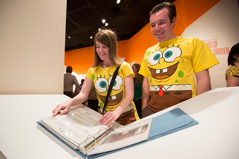 SpongeBob SquarePants super fans Sefra and Jordan Orlick browse through a binder of SpongeBob SquarePants production paraphernalia.