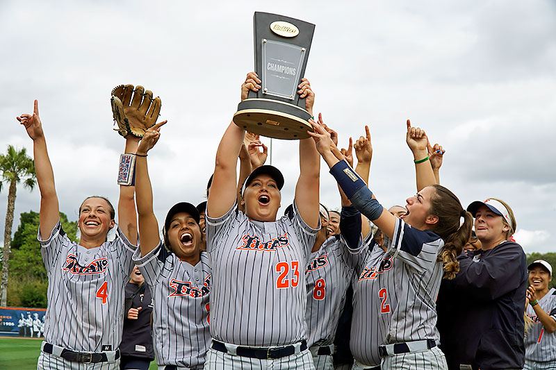 Titan softball team hoisting the Big West Championship trophy.