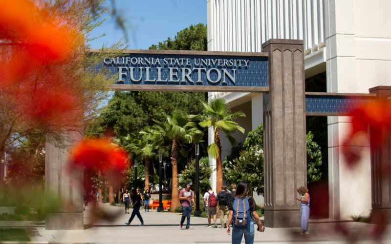 Students walk through campus gateway