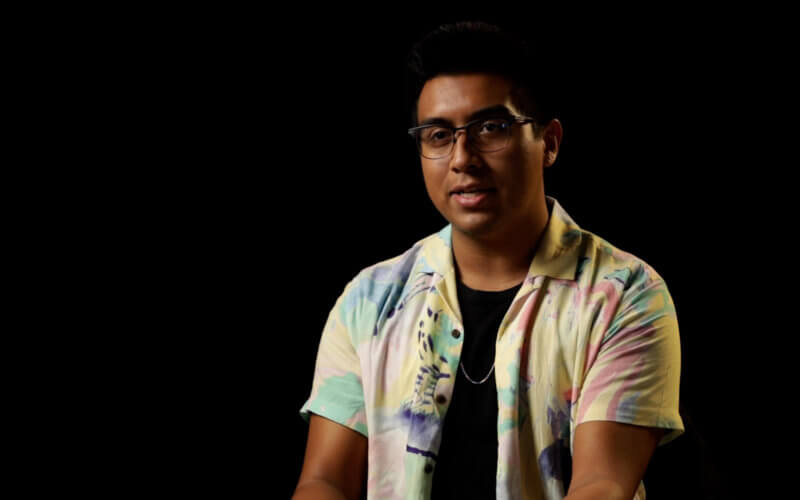 a man wearing eyeglasses sitting