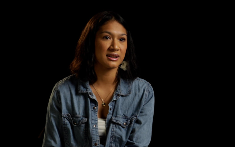 a woman in a blue denim top, white blouse