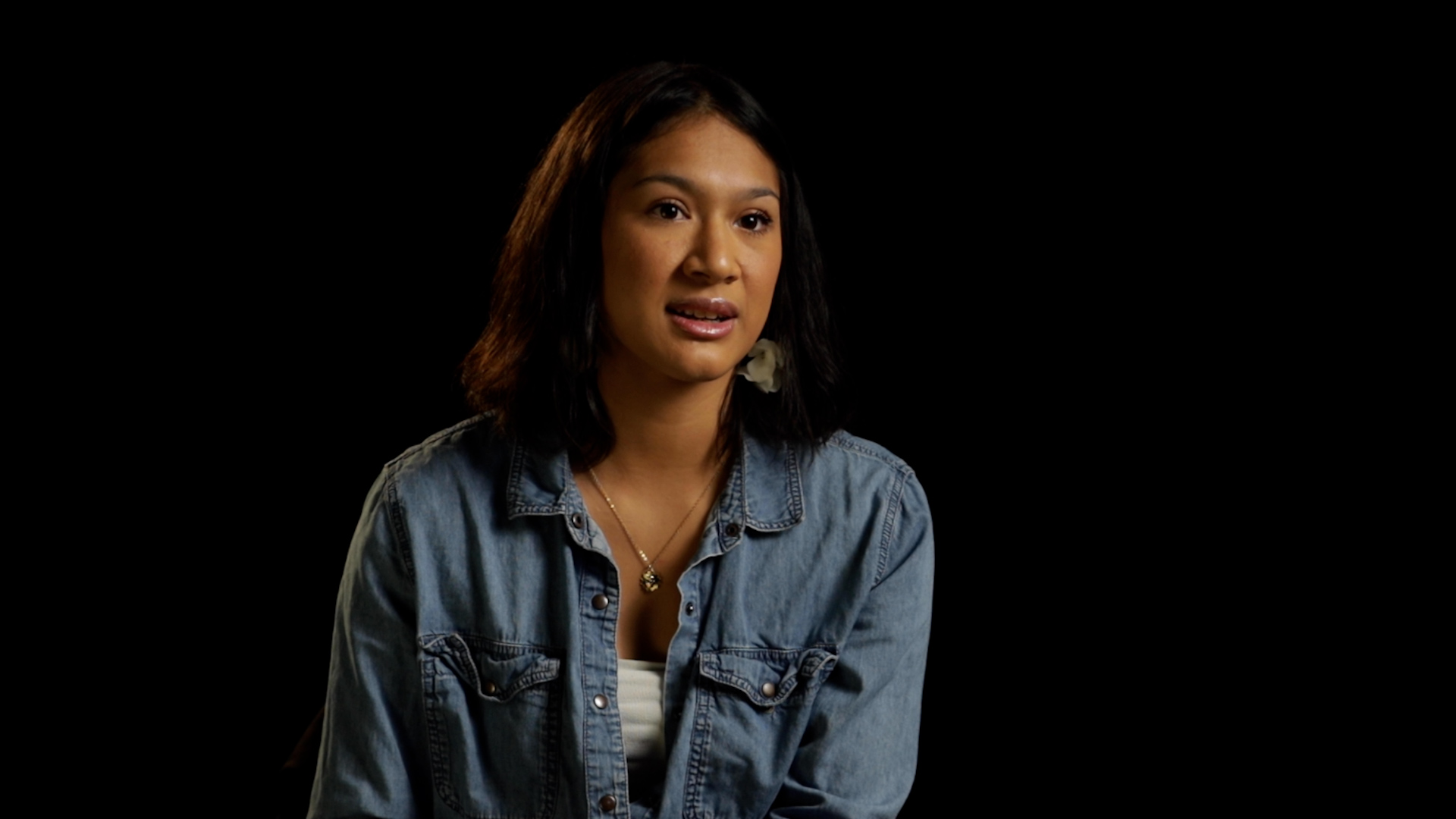 a woman in a blue denim top, white blouse