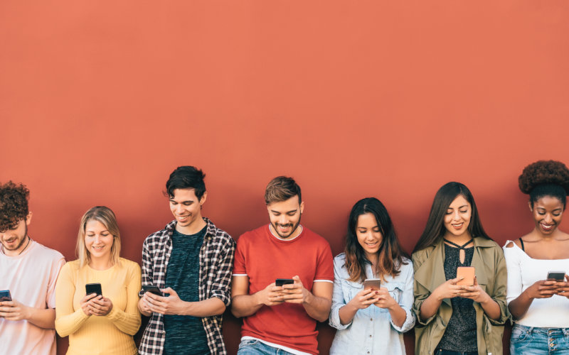 Group young people using mobile smartphone outdoor