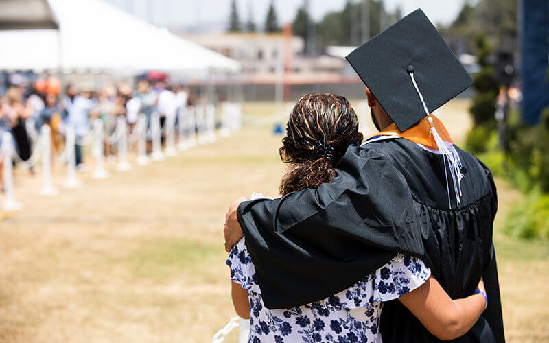 Graduate embracing mother