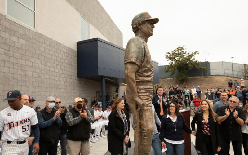 bronze statue of a man in baseball uniform