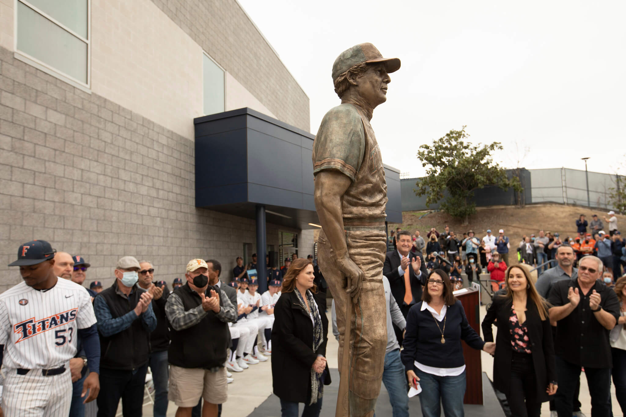 bronze statue of a man in baseball uniform