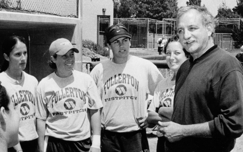 man talking to women athletes