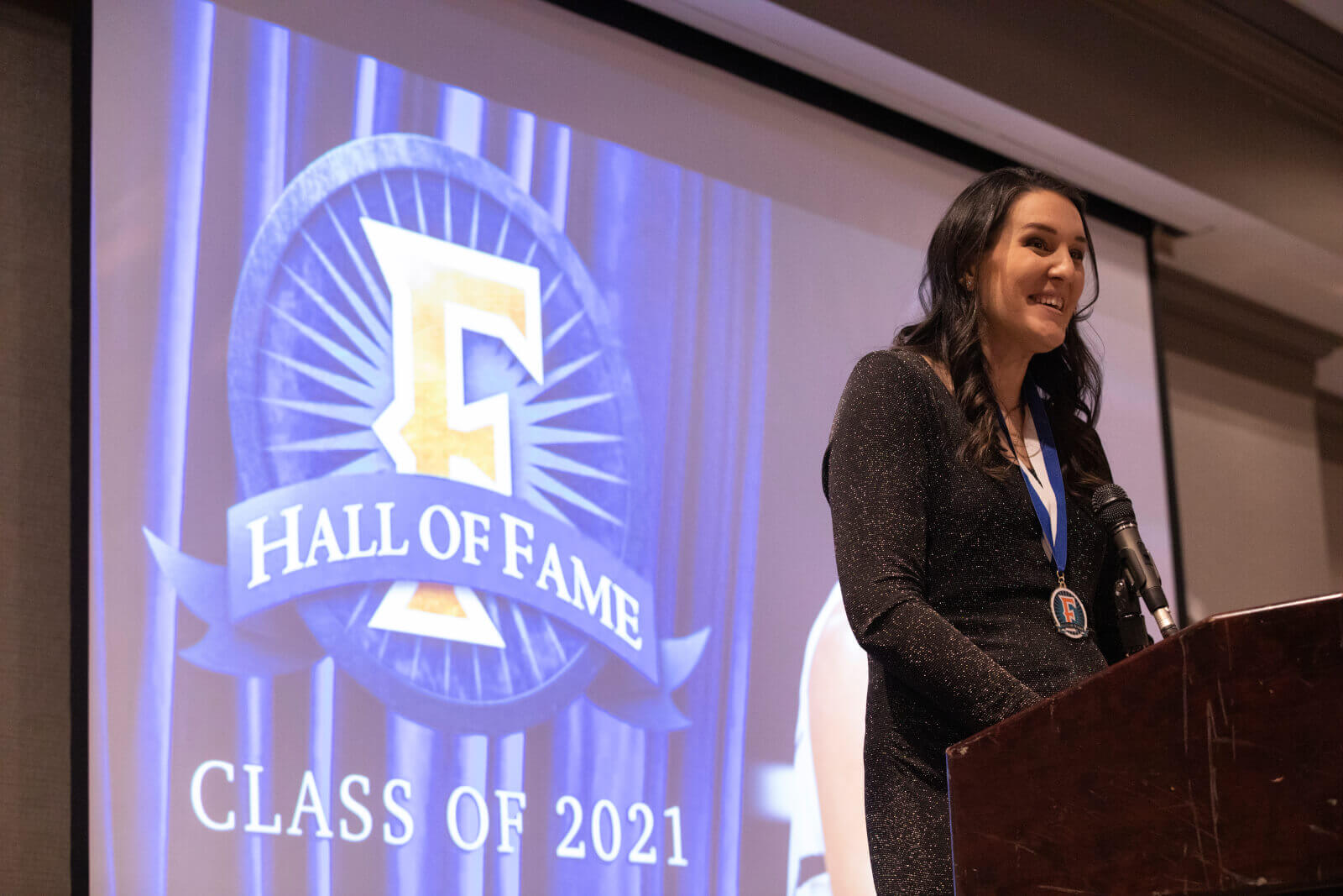 Erin (Saddler) Henry stands at podium