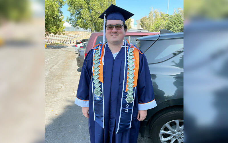 Bronson Vazquez poses for photo in Commencement regalia