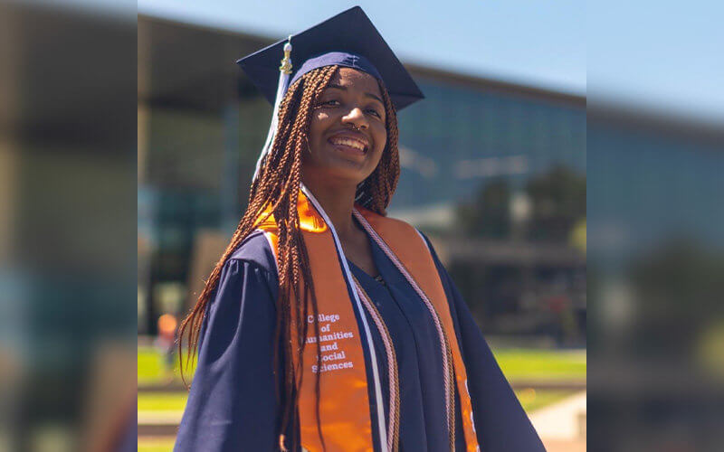 Janae Scott poses for photo in regalia