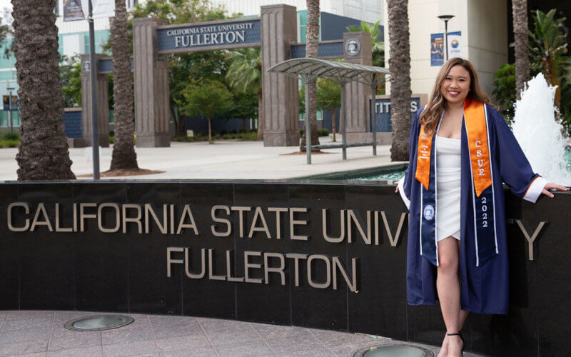Vivian Yenson posing in front of "California State University, Fullerton" sign