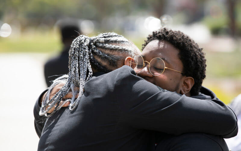 Criminal Justice Lecturer Monishia Miller, left, embraces Torrell Foree, the Coordinator of the African American Resource Center.