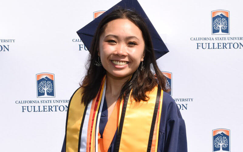 Kim Pham poses in commencement regalia