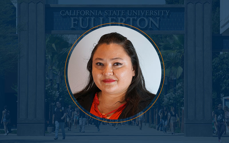 Female student wearing a red blouse with some of her hair pulled back with a Cal State Fullerton image in the background