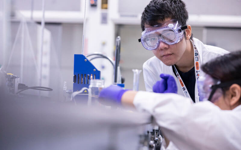 Tom Tran, left, checks the temperature of an experiment during the STEM Academy.