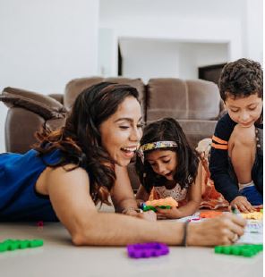Woman and two children playing with toys