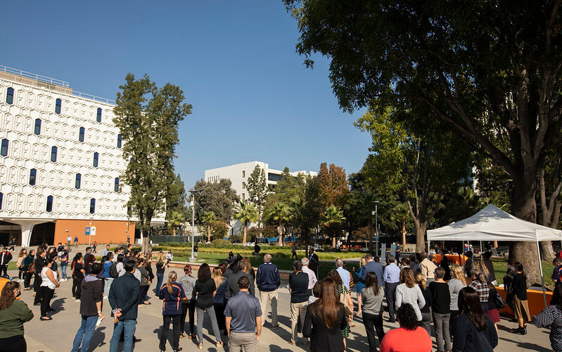 Group gathers around public speaker