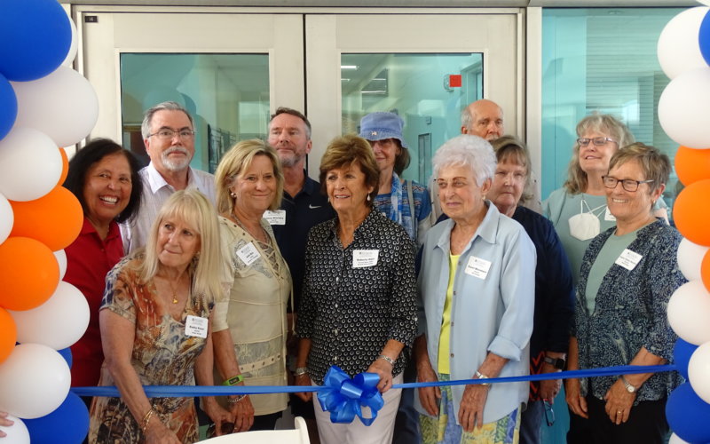 CSUF Kinesiology and Public Health Emeriti cutting a ribbon for their wall unveiling.