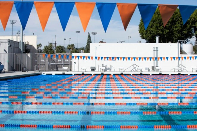 new pool with orange and blue lane dividers and a banner of blue and orange pennants hangs over the pool