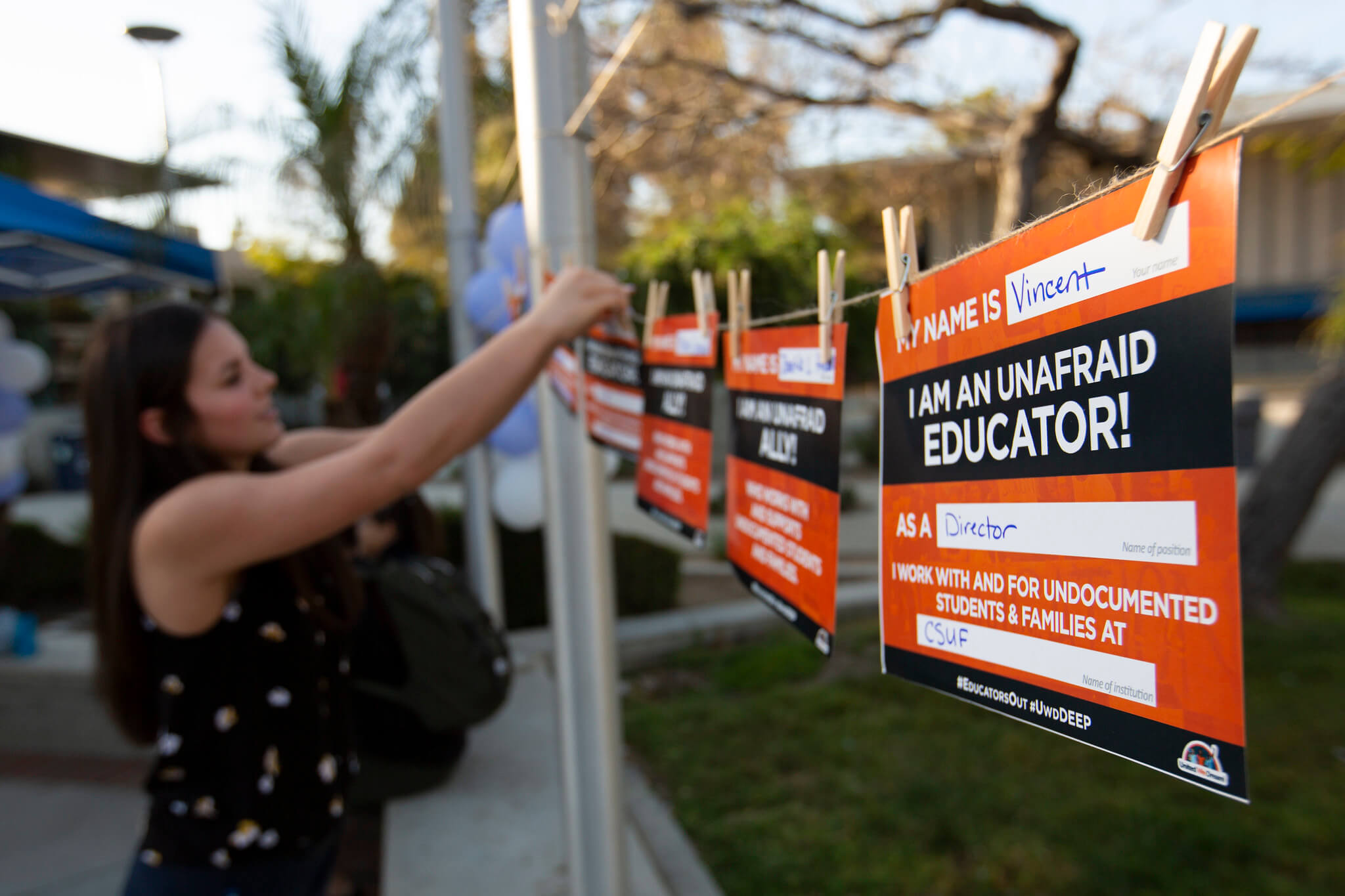 Woman hangs up support sign