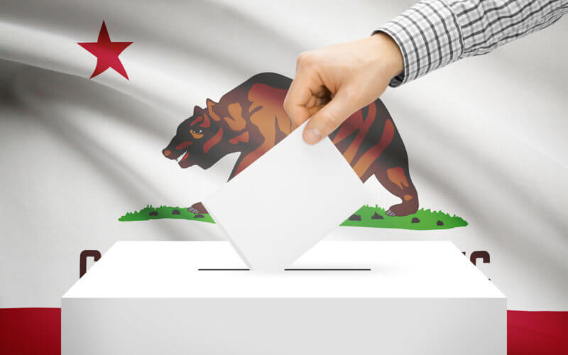 Ballot box with national flag on background - California