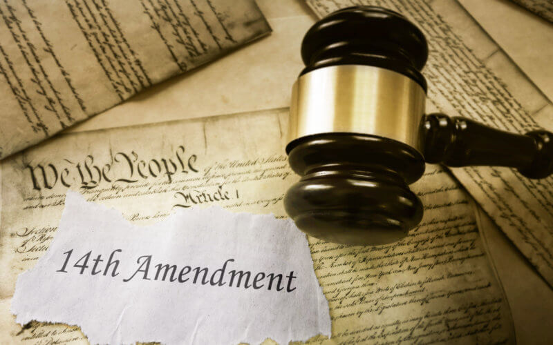 14th Amendment news headline on pages of the US Consitution
