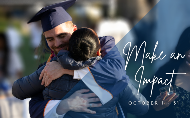 student wearing graduation regalia hugging a family member